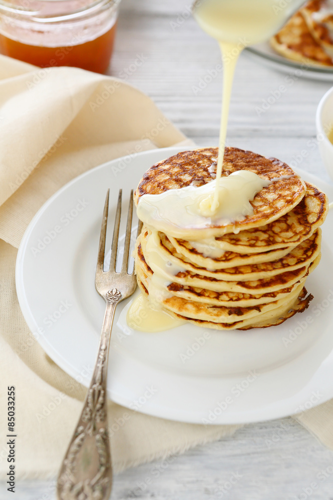 Stack of pancakes with condensed milk