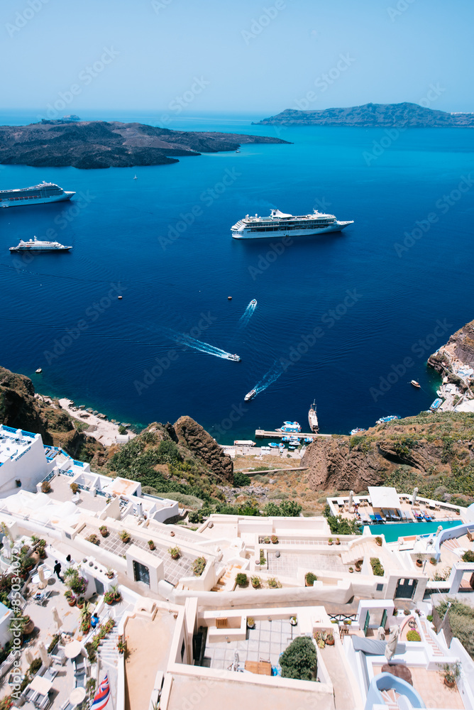 Terraced apartment suites in Fira, with a view towards the Caldera, the volcano island and the tourist packed cruisers