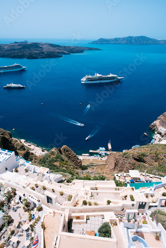 Terraced apartment suites in Fira  with a view towards the Caldera  the volcano island and the tourist packed cruisers