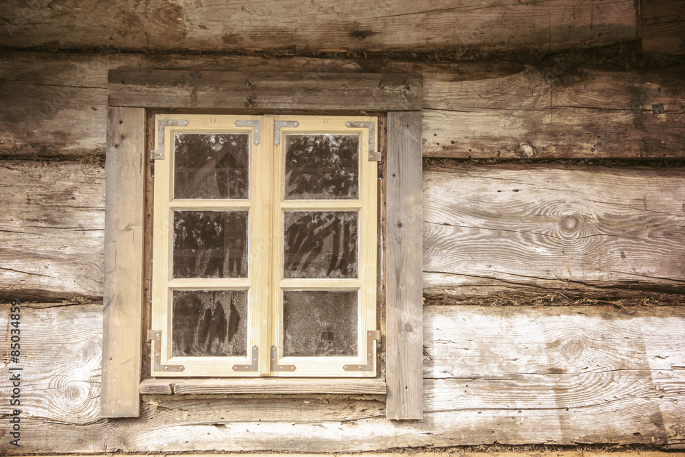Small window in wooden village house cottage.