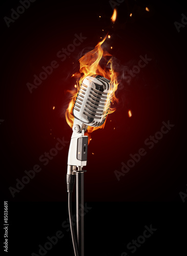 Retro singing microphone in fire