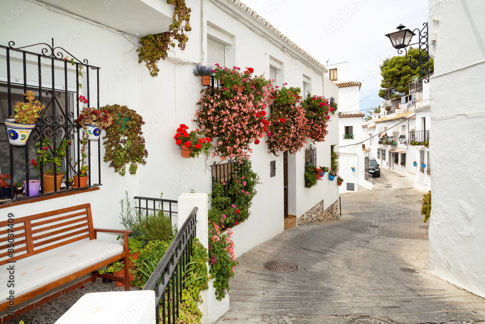 Fototapeta Street with flowers in the Mijas town, Spain.