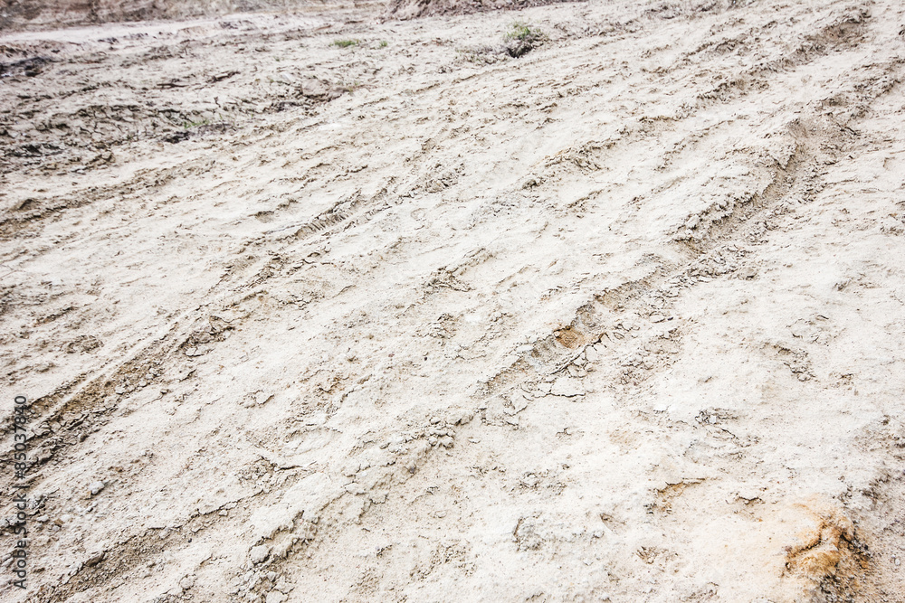 Dirty grunge tyre track on wet sand texture Dirty grunge tyre track on wet sand texture