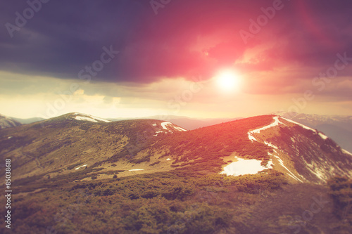 Landscape in the mountains:snowy tops and spring valleys.