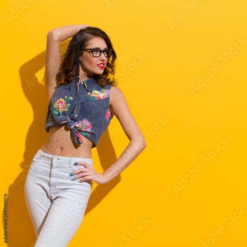 Young Woman Against Sunny Yellow Wall