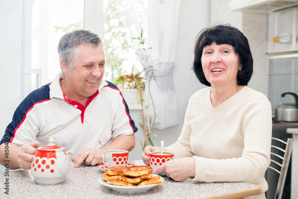 cheerful elderly couple in kitchen. cheerful elderly couple in kitchen.