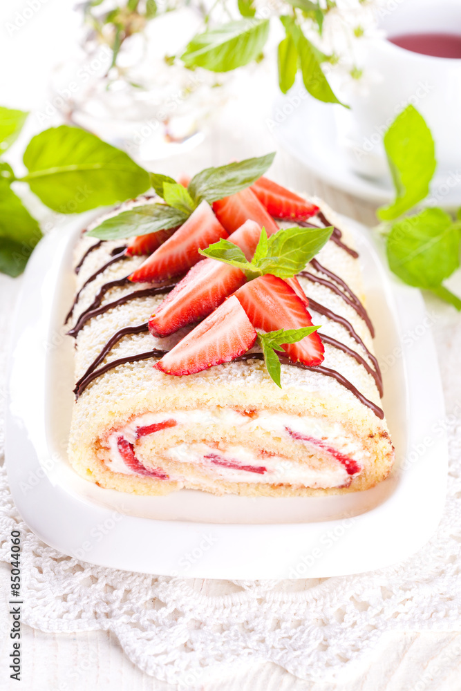 Homemade sponge roll with strawberries and mascarpone cream