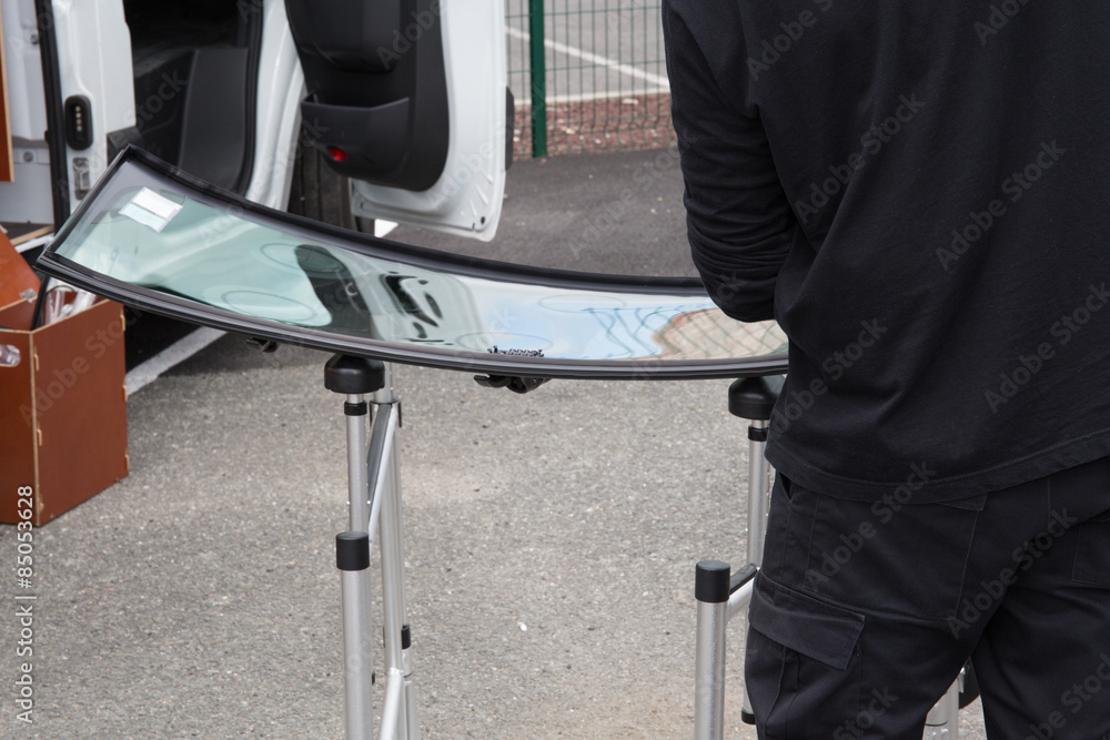 Glazier removing windshield or windscreen on a car