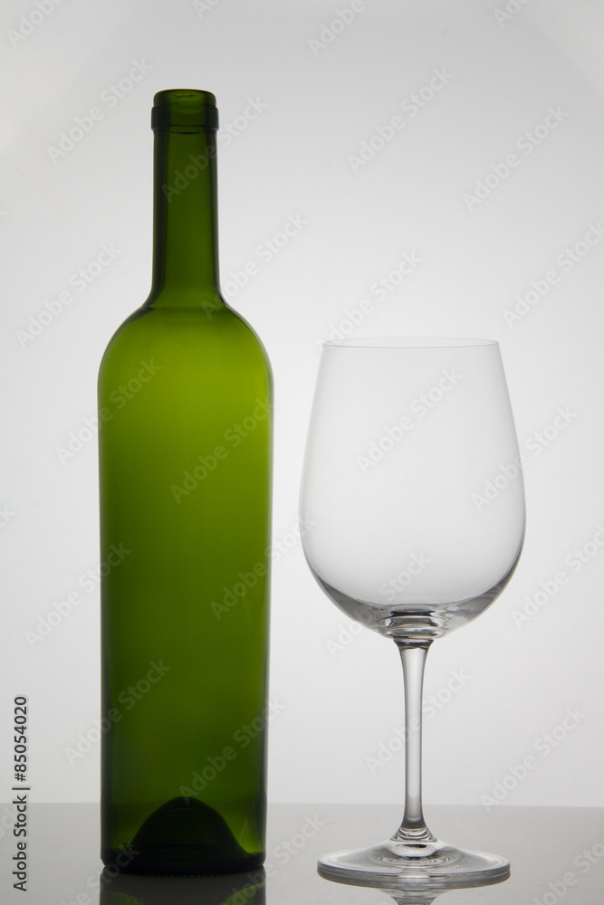 Empty bottle of wine with empty glass of wine on white background Empty bottle of wine with empty glass of wine on white background