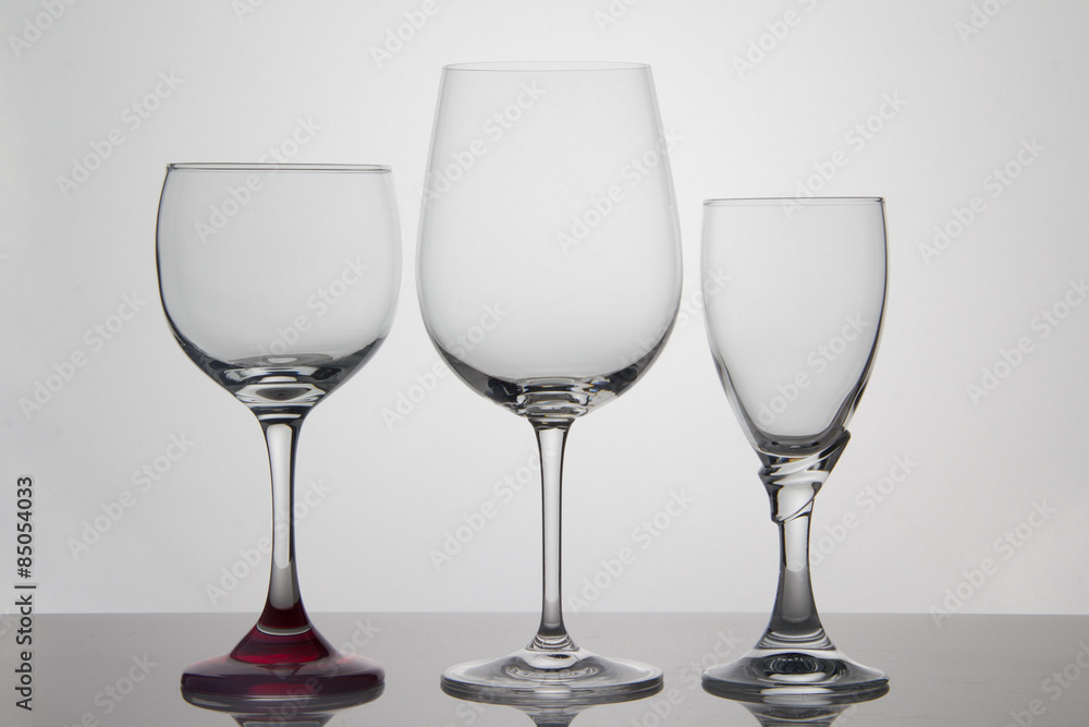 Empty glasses of wine on white background