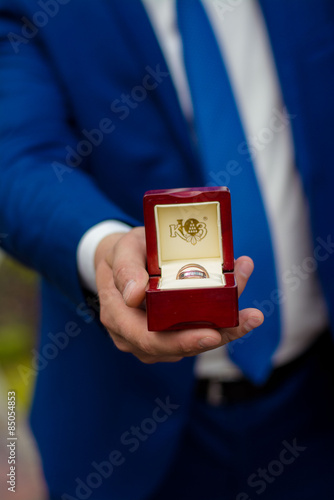 Fototapeta Naklejka Na Ścianę i Meble -  Cropping image of groom holding a box with wedding rings
