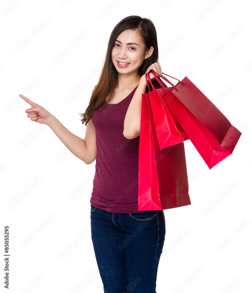 Young girl hold with shopping bag and finger point up Young girl hold with shopping bag and finger point up