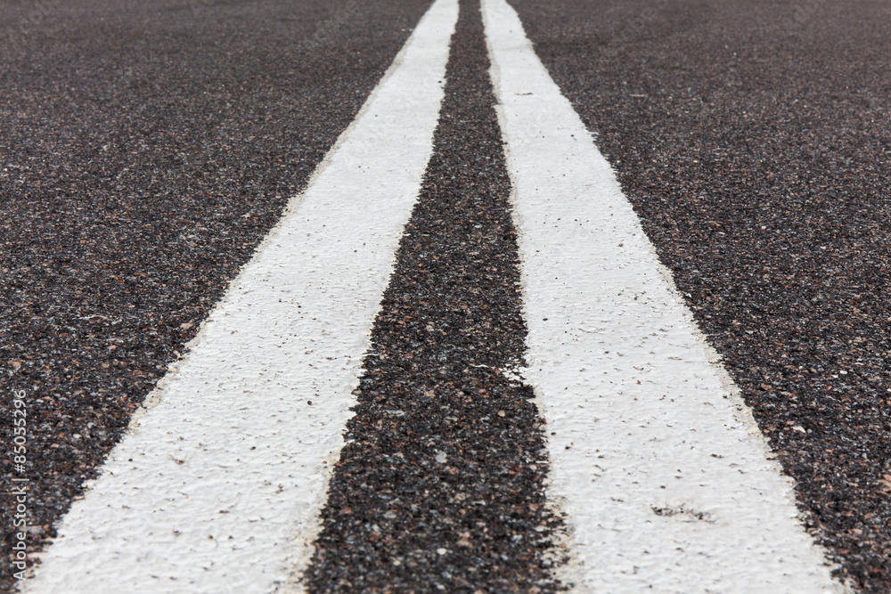 Obraz premium Asphalt road with white double solid line.