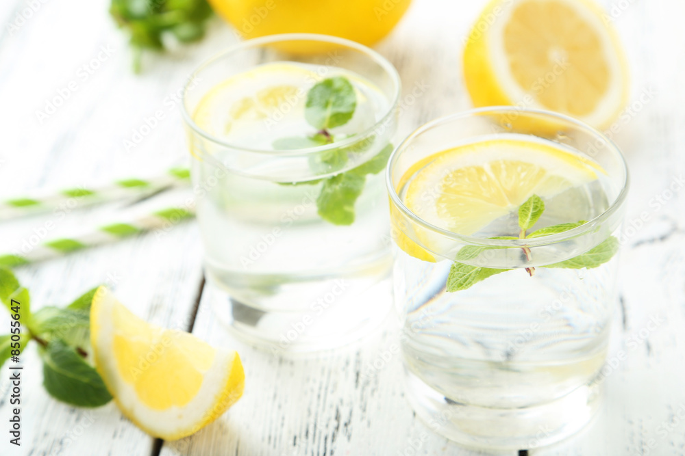 Fresh lemonade with lemon on white wooden background Fresh lemonade with lemon on white wooden background