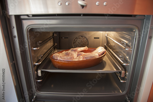 oven with raw lamb in tray
