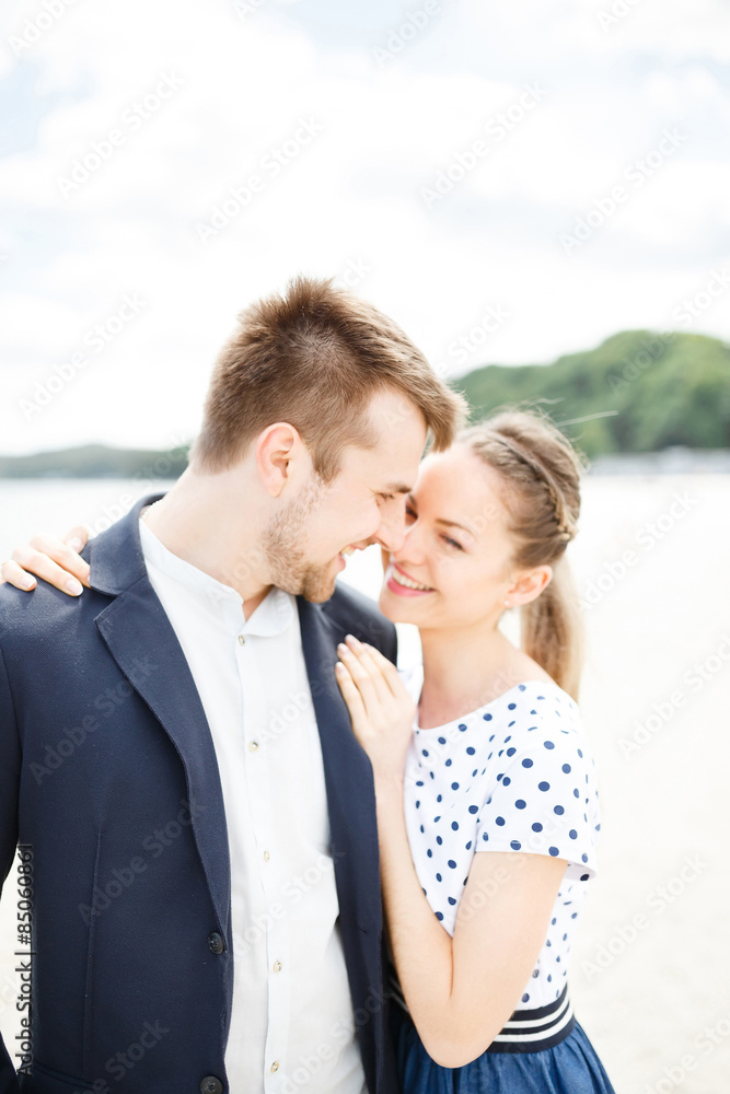 European couple relaxing on the sea beach hugging each other and talking European couple relaxing on the sea beach hugging each other and talking