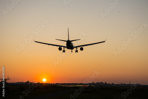 Plane is landing during sunrise. © New Visuals