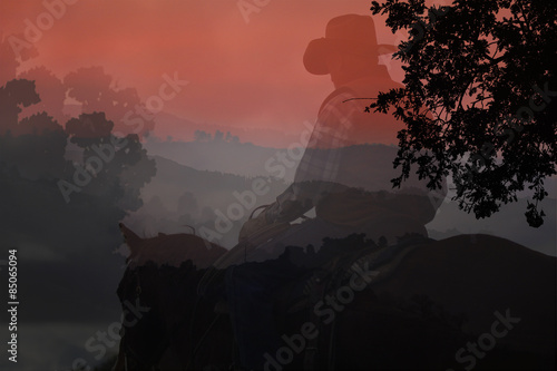 An artistic expression of a cowboy riding his horse in the mountains with black silhouette trees in a red background with text area.