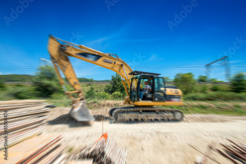 Excavator machine work in construction site, blurred motion view