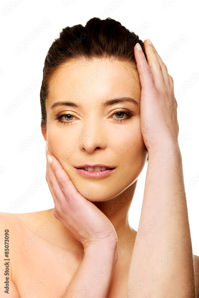 Spa woman with make up touching her face.