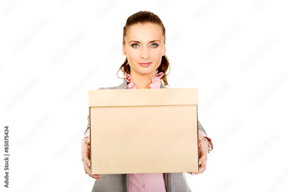 Sad businesswoman carrying box. Sad businesswoman carrying box.