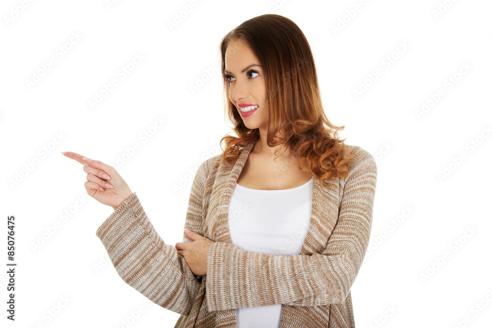 Happy smiling woman pointing aside. Happy smiling woman pointing aside.