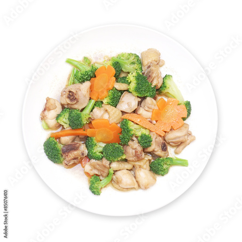 stir fried chicken with broccoli and carrot on plate isolated white background, top view
