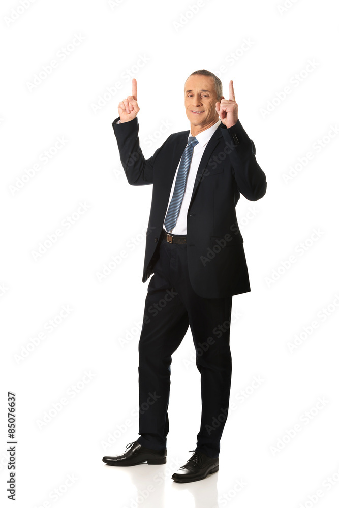 Businessman pointing upwards 