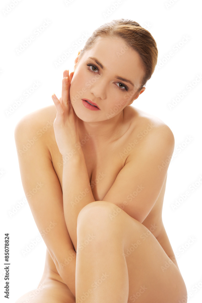 Spa woman sitting with her knees close to chest. Stock Photo