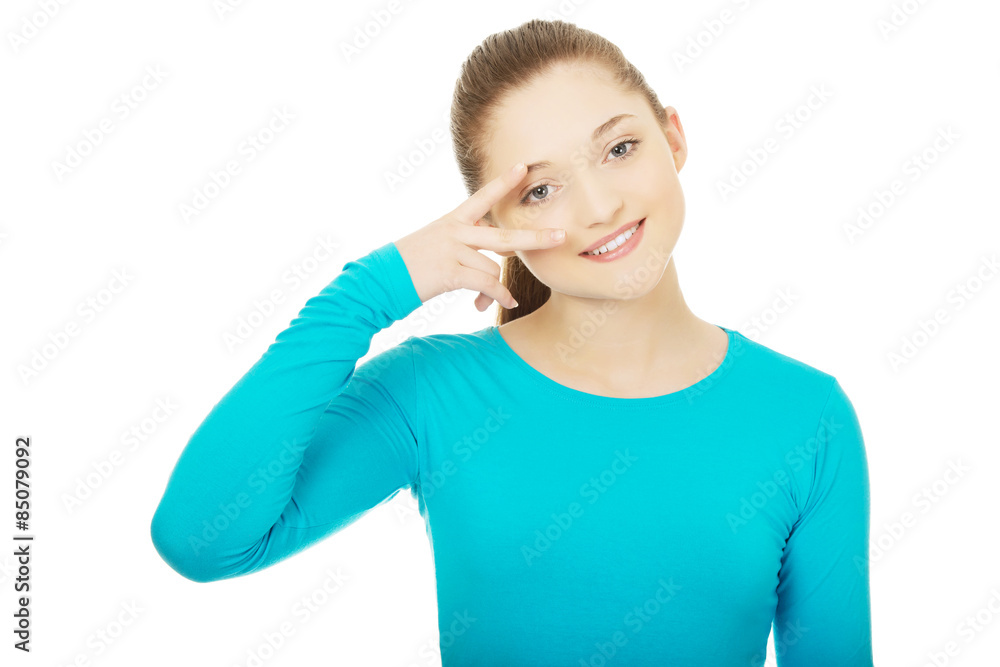 Happy teenager with victory sign on eye. Happy teenager with victory sign on eye.