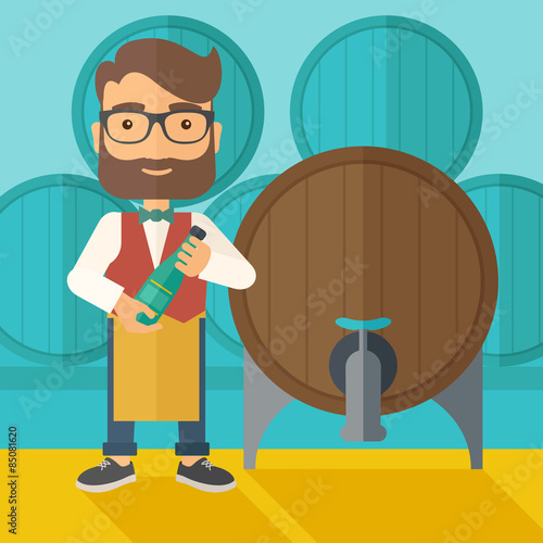 Wine maker inspecting wine from barrel.