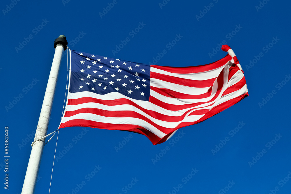 United States flag with blue sky background 