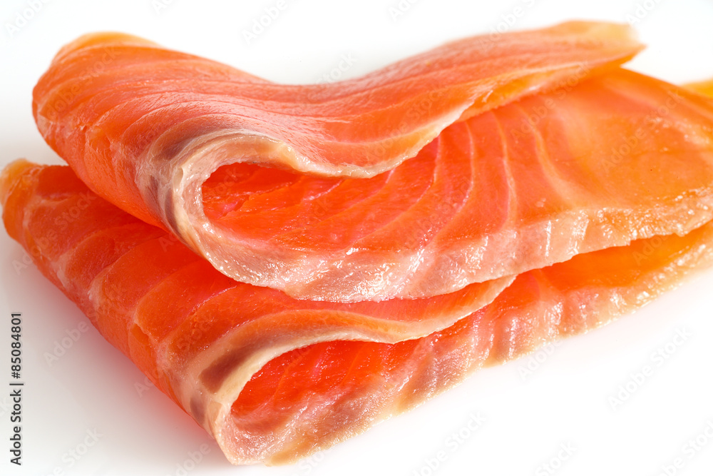 two slices of salmon on a white