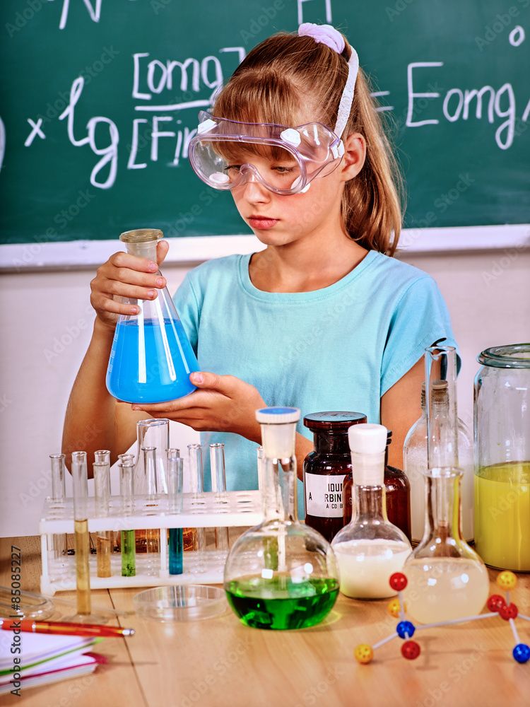 Child in chemistry class. Child in chemistry class.