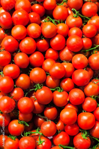 Red Cherry tomatoes in market close up, may use as background. .