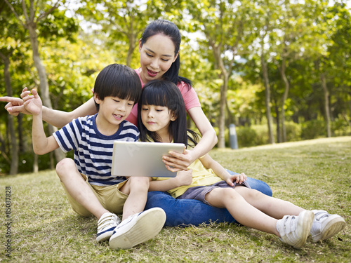 asian mother and children using tablet computer