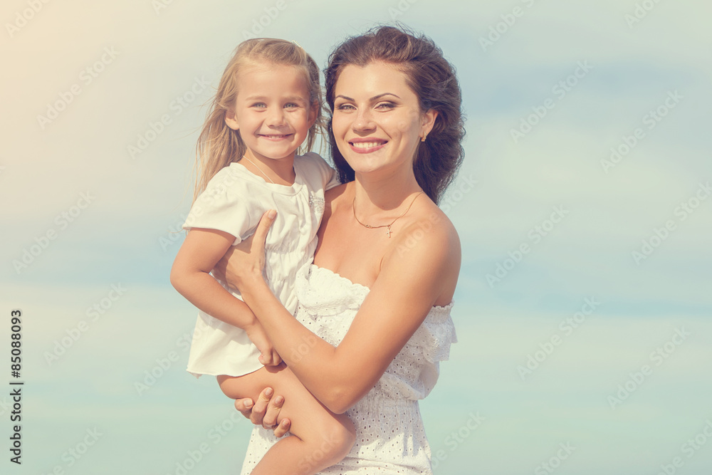 Happy beautiful mother and daughter enjoying beach time Happy beautiful mother and daughter enjoying beach time