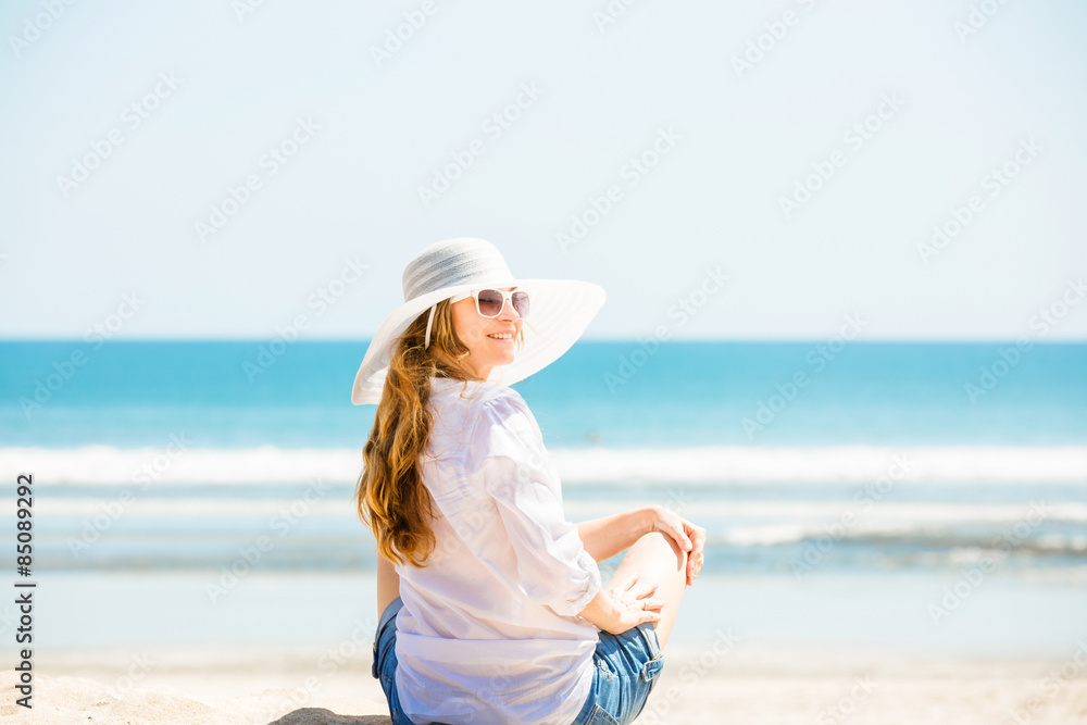 Beautifil young woman sitting on the beach at sunny day enjoing Beautifil young woman sitting on the beach at sunny day enjoing