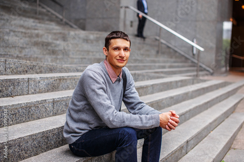 Smart guy in grey shirt and jeans
