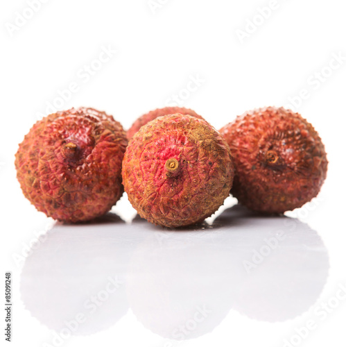 Ripe lychee fruits over white background