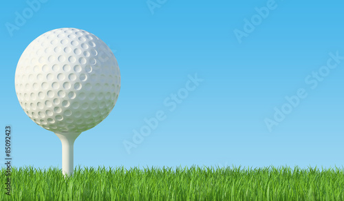 Golf ball on the green lawn, the grass with blue sky.