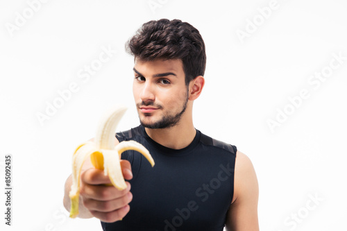 Handsome young man holding banana