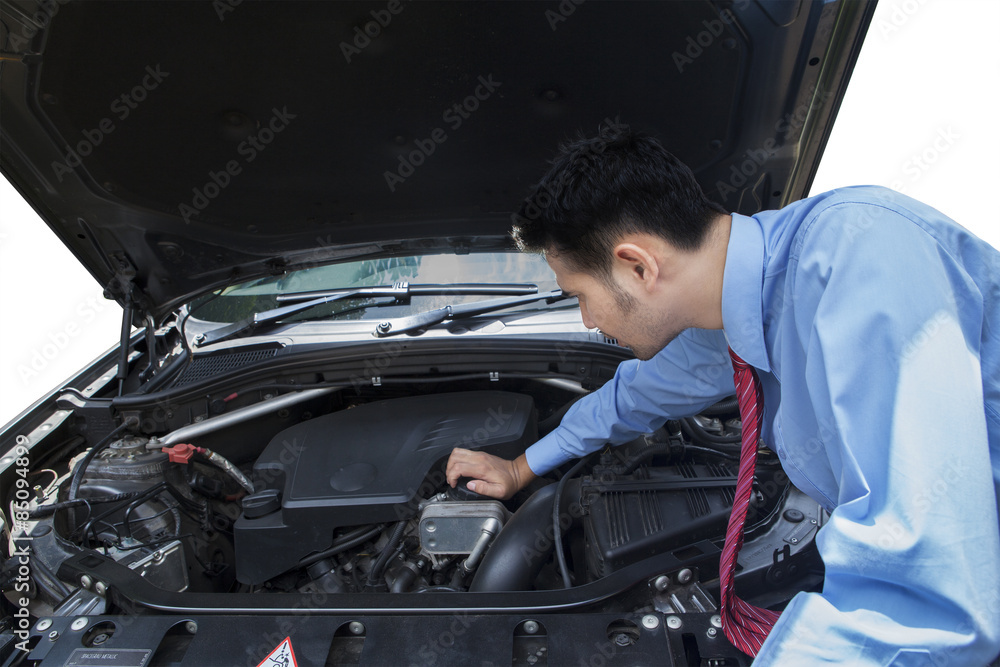 Entrepreneur checking the car machine Entrepreneur checking the car machine