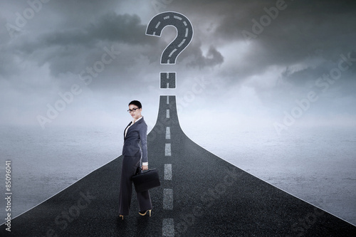 Female worker with question sign on highway