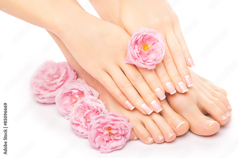 Relaxing pedicure and manicure with a pink rose flower Relaxing pedicure and manicure with a pink rose flower