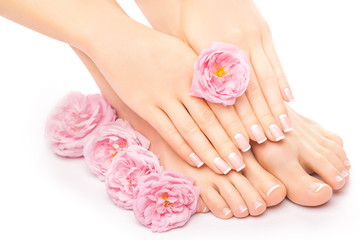 Relaxing pedicure and manicure with a pink rose flower
