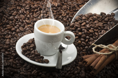 Cup of coffee on the table with seeds