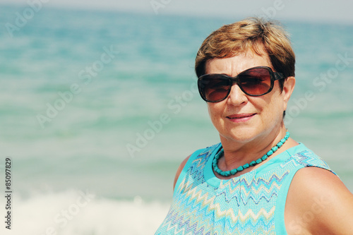 portait of happy senior woman on the beach