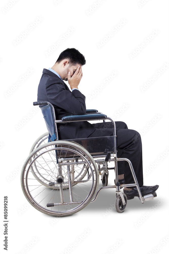 Sad entrepreneur sitting in wheelchair Sad entrepreneur sitting in wheelchair