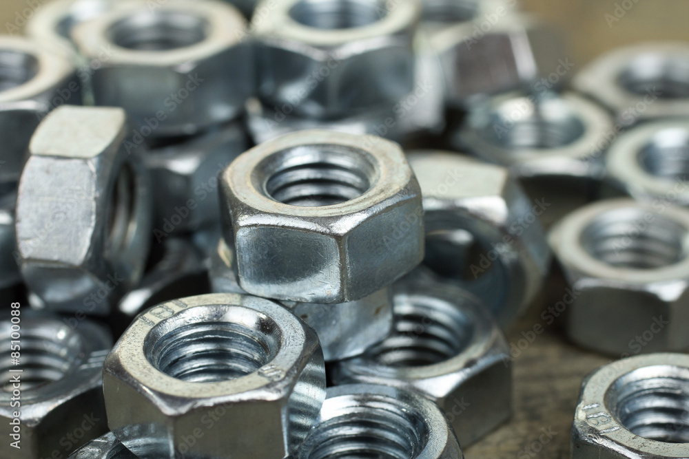Working tools. Fixing elements (nuts) on wooden background Working tools. Fixing elements (nuts) on wooden background